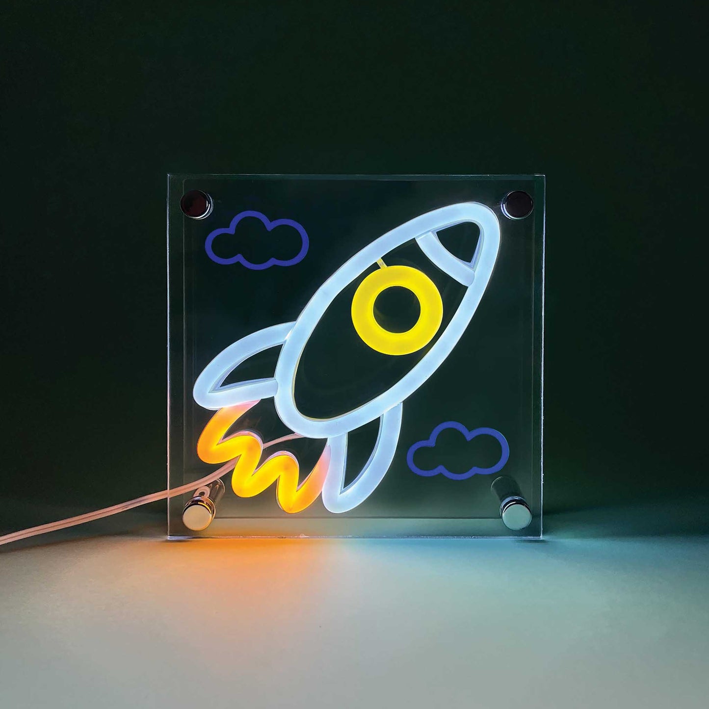 Neon sign of a rocket ship with clouds on a dark background