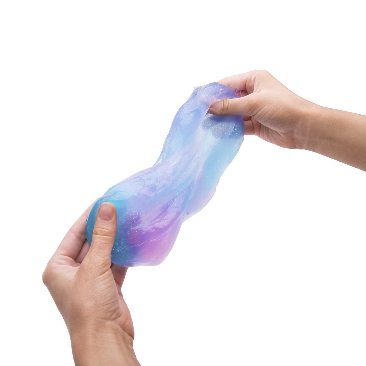 Multicolored slime being held between two hands on a white background