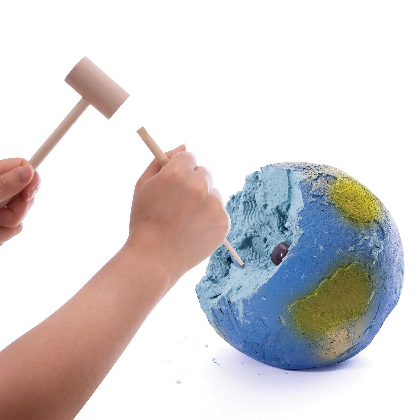 Model of Earth globe being dug out with a mallet on a white background