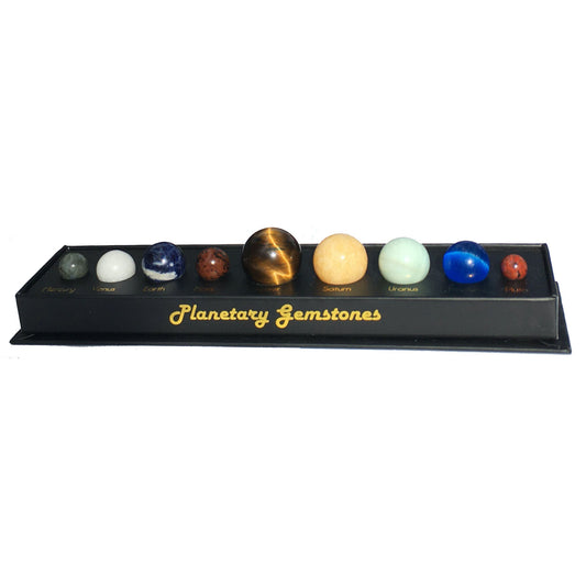 Set of 'Planetary Gemstones' on a black display stand with gold text.