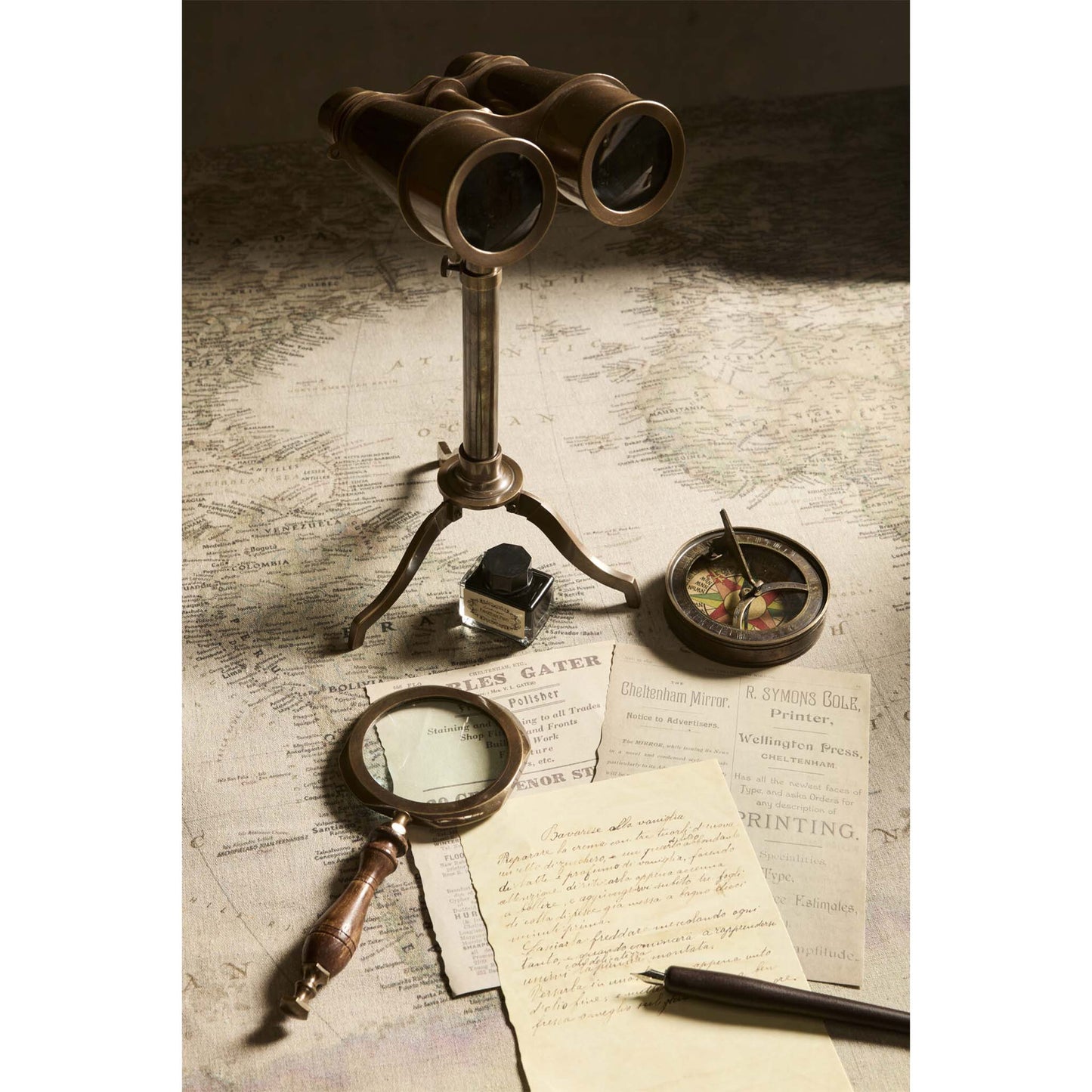 Vintage binoculars, magnifying glass, compass, and documents on a map background