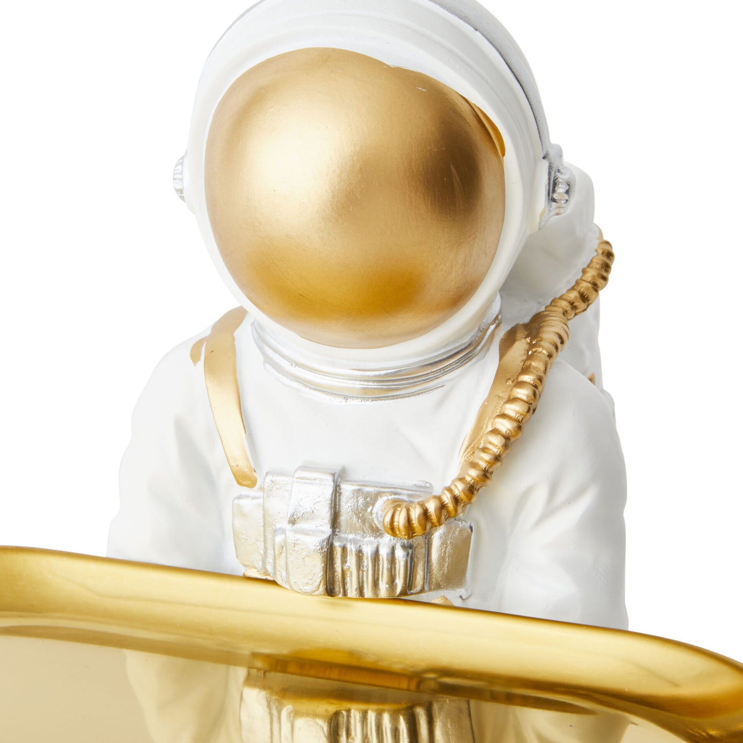 Decorative figurine of an astronaut in a white suit with gold helmet and equipment on a white background