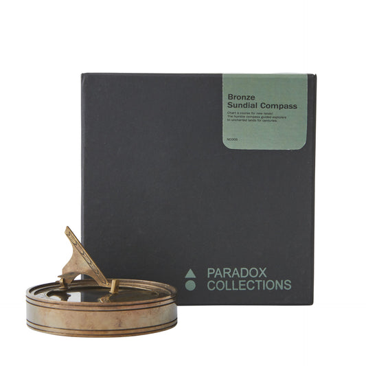 Bronze sundial compass with Paradox Collections packaging on a white background