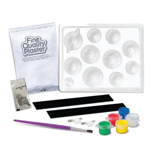 Art supply kit with plaster mold, paint, and tools on a white background