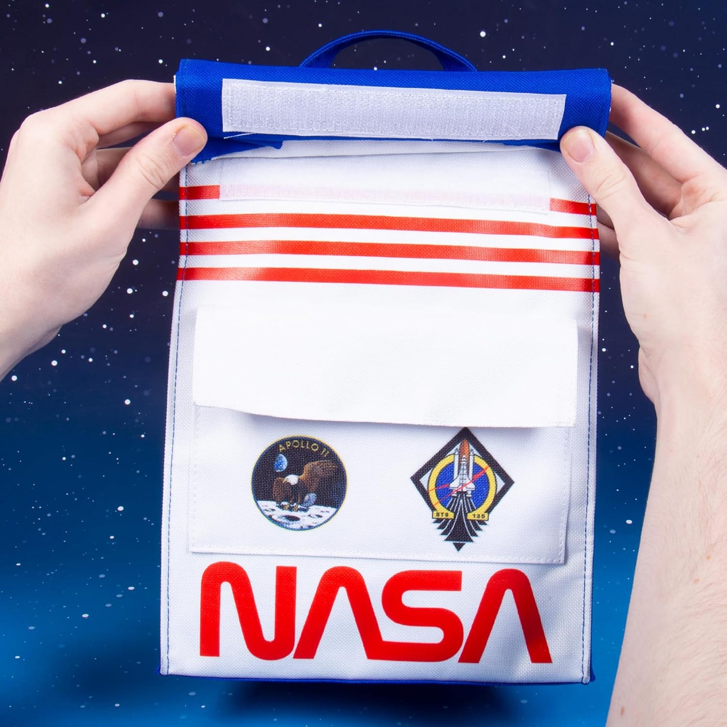 NASA-themed pouch held by hands against a space-themed background