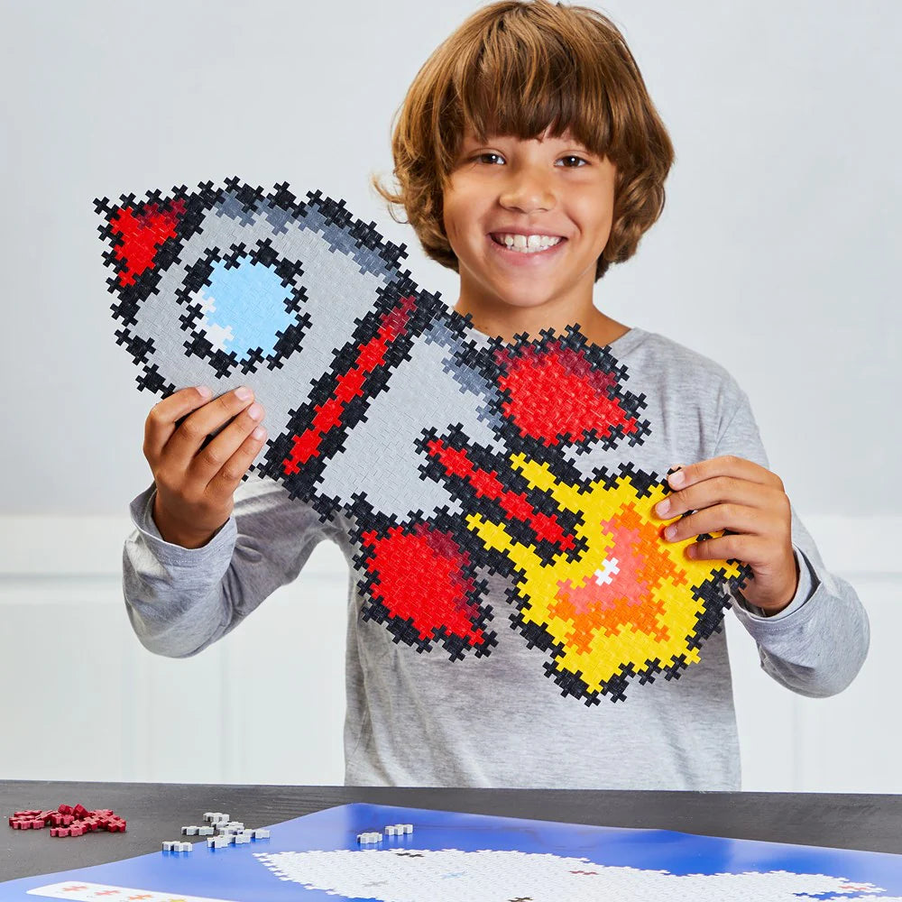 Child holding a completed puzzle of a dragon design with red, yellow, and gray colors.