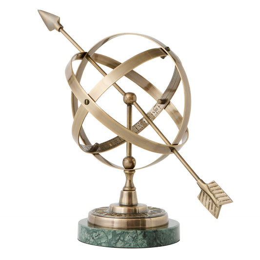 Decorative brass armillary sphere with arrows on a white background