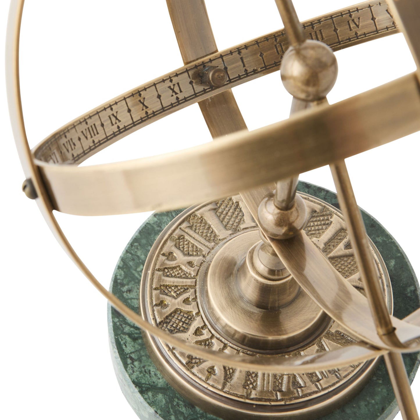 Brass astrolabe on a green marble base with white background