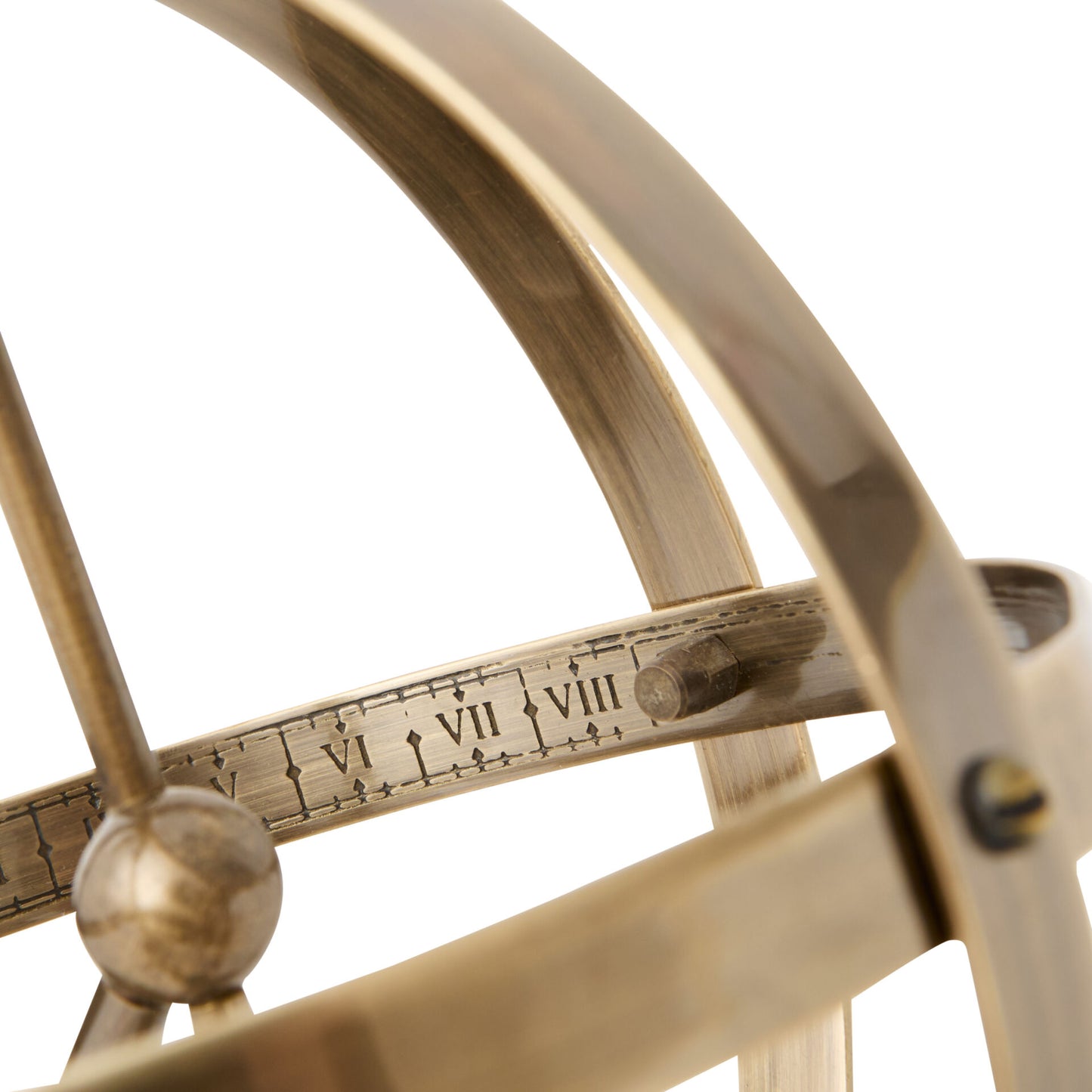 Close-up of a brass compass with engraved numbers on a white background