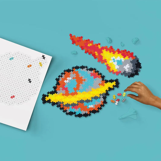 Colorful puzzle of a rocket ship on a blue background with a hand placing pieces.