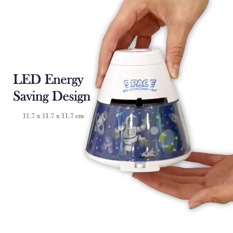 Hand holding a space-themed LED night light with 'SPACE' branding on a white background.