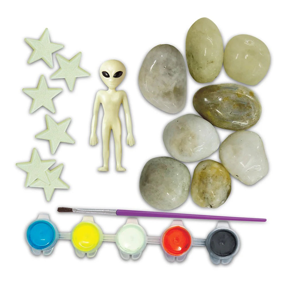 Set of rocks, alien figure, glow sticks, and paint set on a white background
