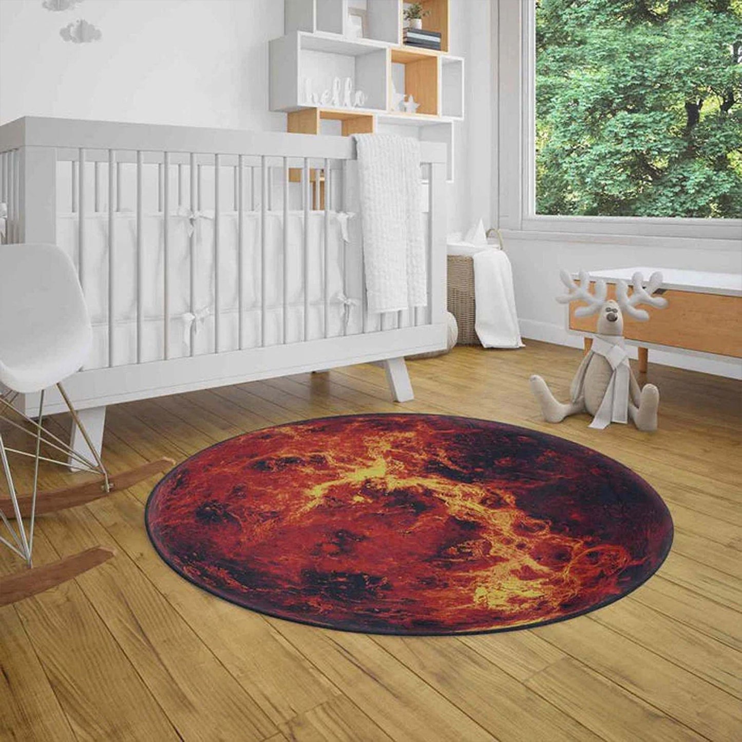 Round red and orange rug on a wooden floor in a nursery with a crib and toys.