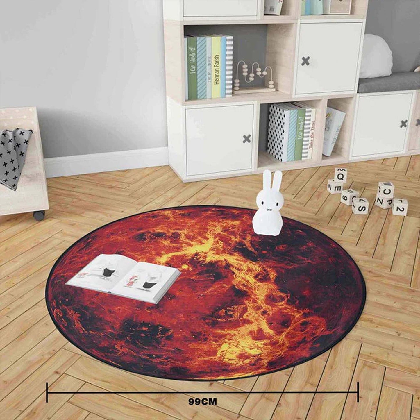 Round lava-patterned rug on a wooden floor with a book and rabbit figurine.