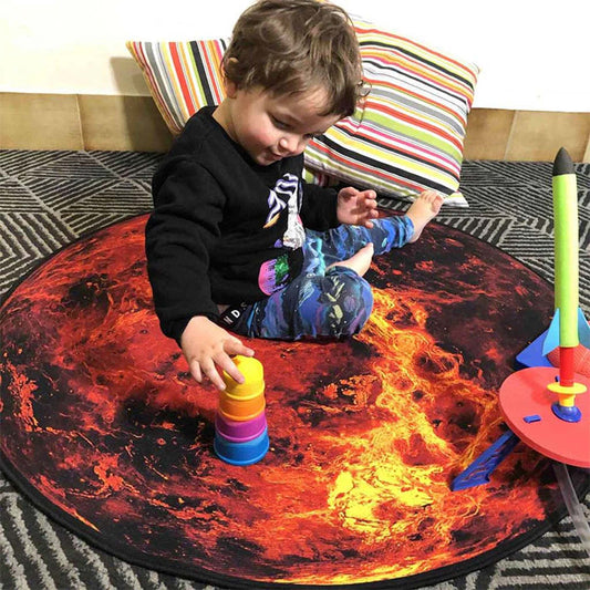 Child playing with colorful toys on a mat designed to look like a planet.