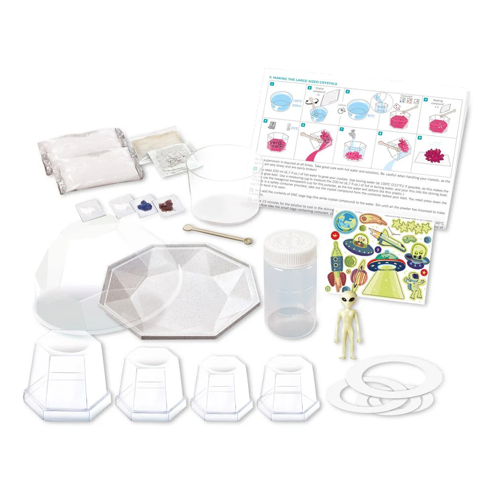 Science experiment kit with moldable material, tools, and instructions on a white background