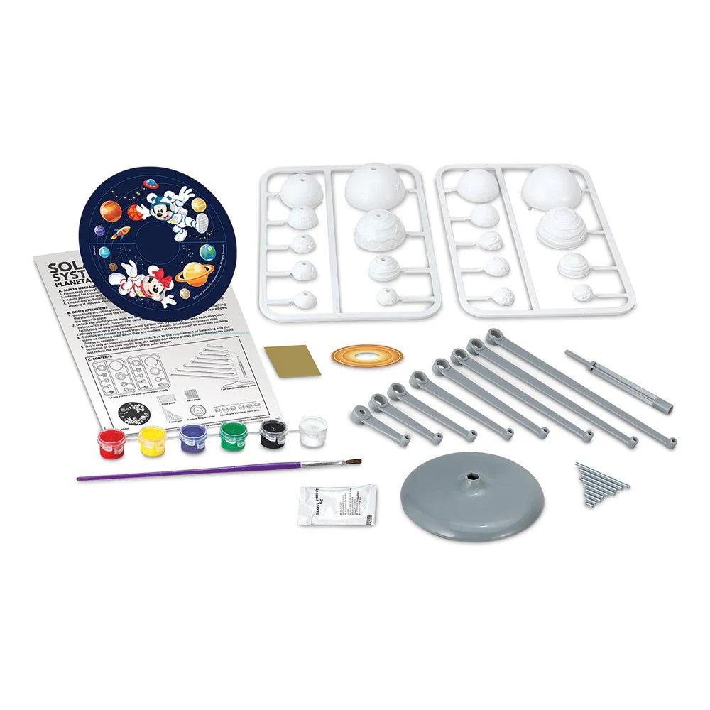 Science kit with model parts, paints, and instructions on a white background