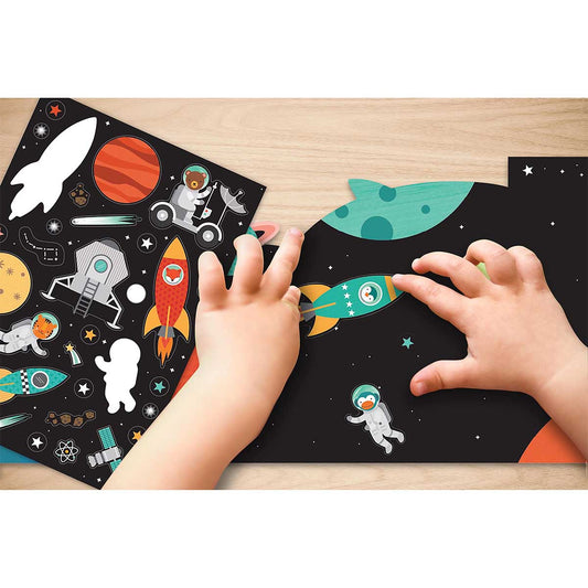Children's hands interacting with a space-themed puzzle on a wooden surface