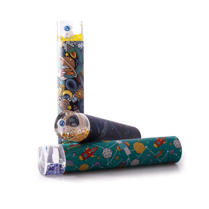 Colorful space-themed items including a cylindrical container, a roll of paper, and a small glass jar on a white background.