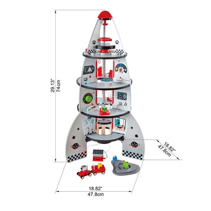 Toy rocket ship with various compartments and toys on a white background, including dimensions.