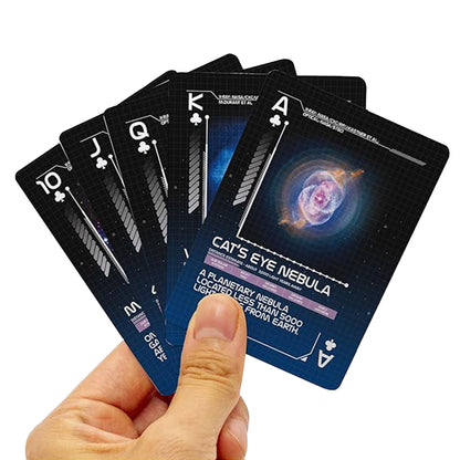 Hand holding a set of playing cards with space-themed designs on the back