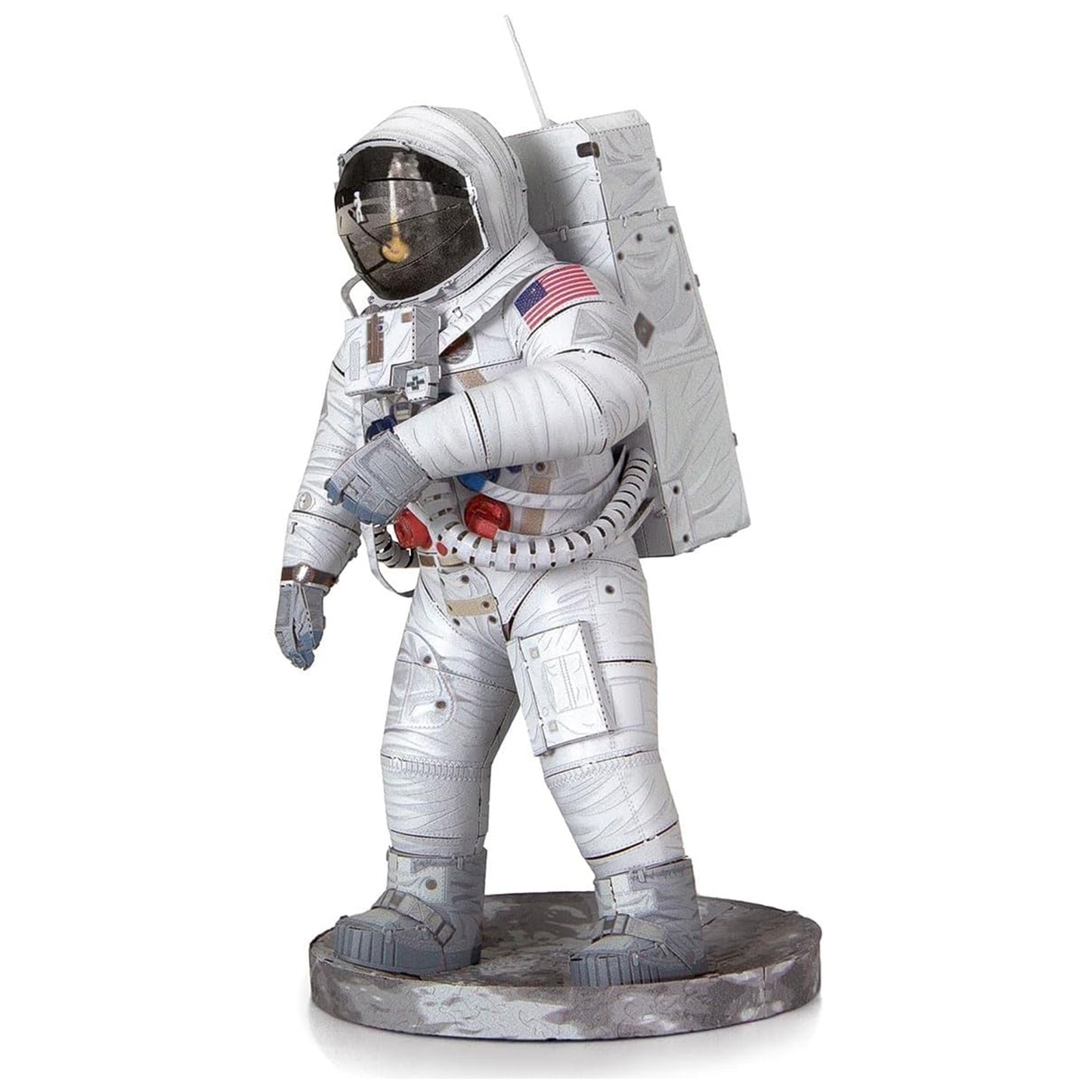 Statue of an astronaut in a white space suit with American flag patch on a white background