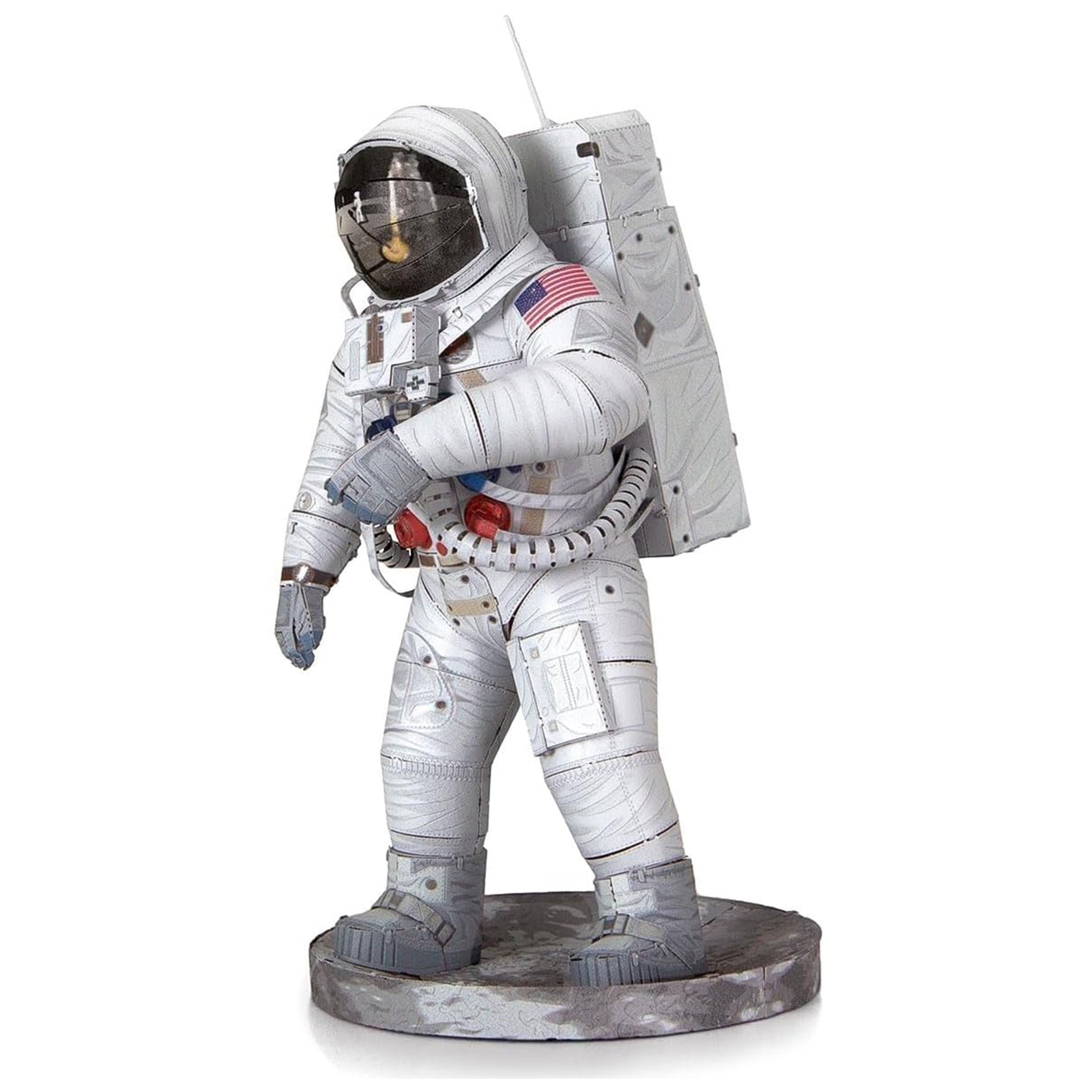Statue of an astronaut in a white space suit with American flag patch on a white background