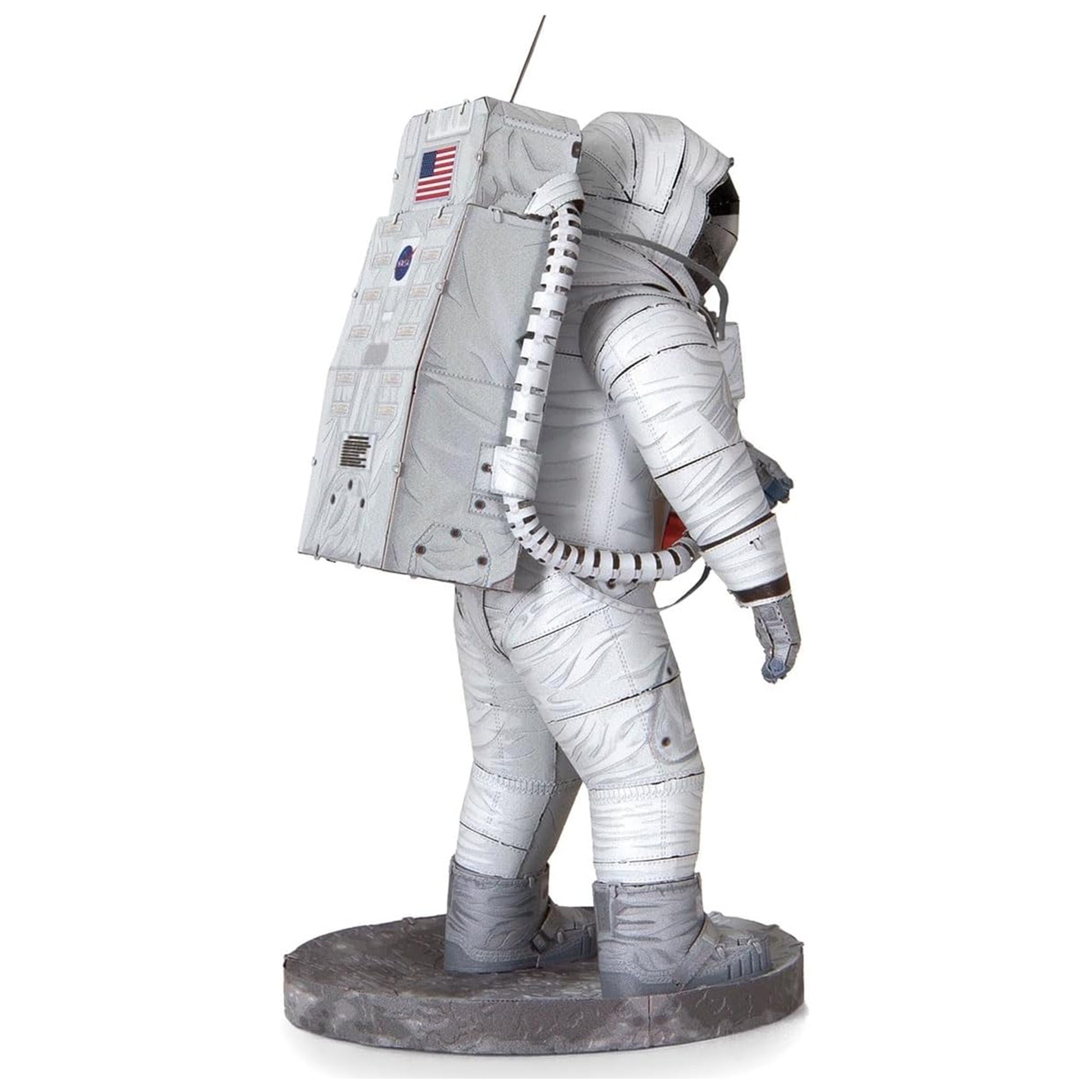 Statue of an astronaut in a space suit with an American flag patch on a white background