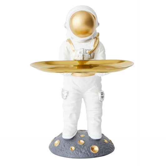 Astronaut figurine holding a gold tray on a white background