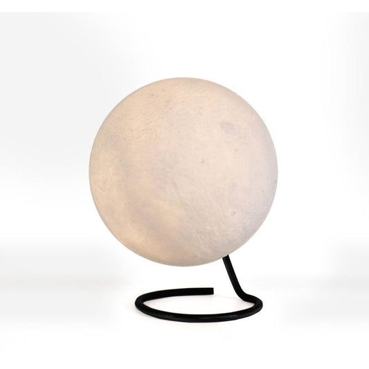 Spherical lamp with a black base on a white background