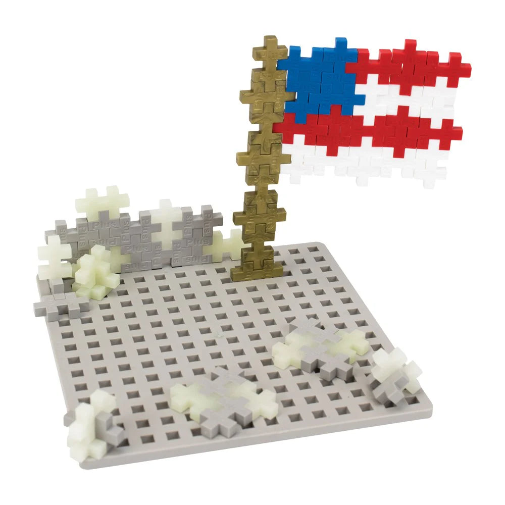 Toy construction set with a flag and base on a white background