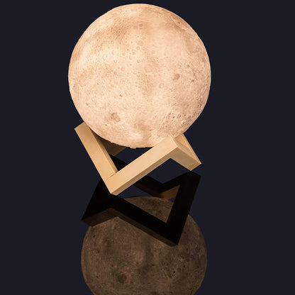 Moon-shaped lamp on a stand with a dark background