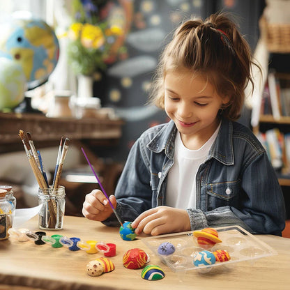 Child painting small figurines at a table with art supplies.