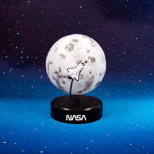 Model of the moon with a space shuttle on a black base, against a starry space background.