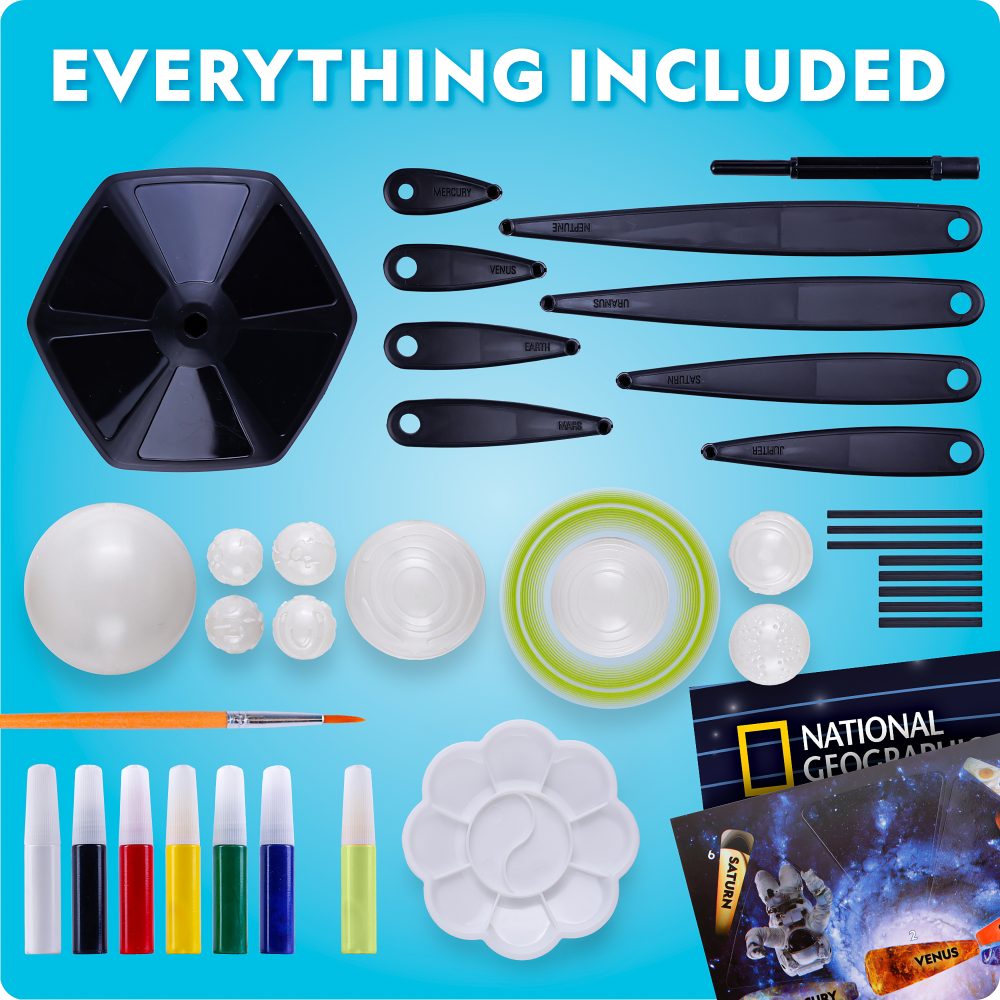 Collection of art supplies including paintbrushes, paint containers, and a National Geographic book on a blue background.