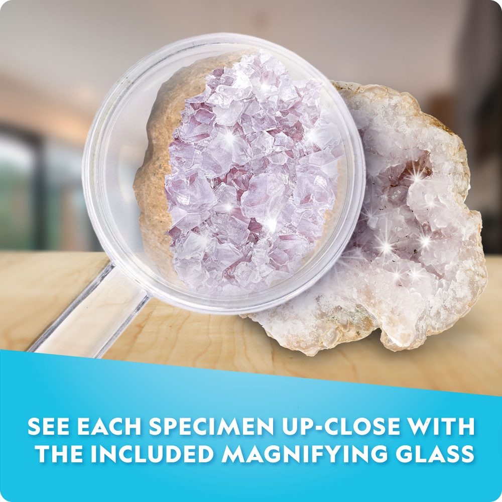 Crystal specimen with a magnifying glass on a wooden surface