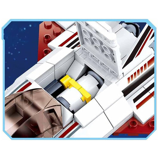 Close-up of a toy spaceship model with visible details on a blue background