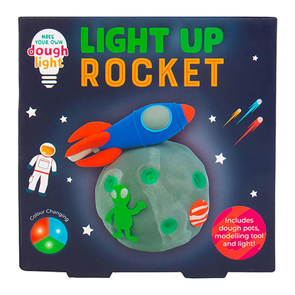 Packaging of a 'Light Up Rocket' toy set with dough, tool, and light features.