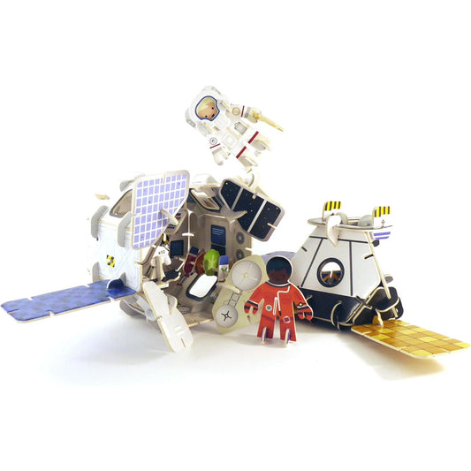 Toy model of a lunar module with astronauts on a white background