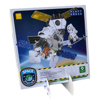 Space station building set packaging with model pieces on a white background