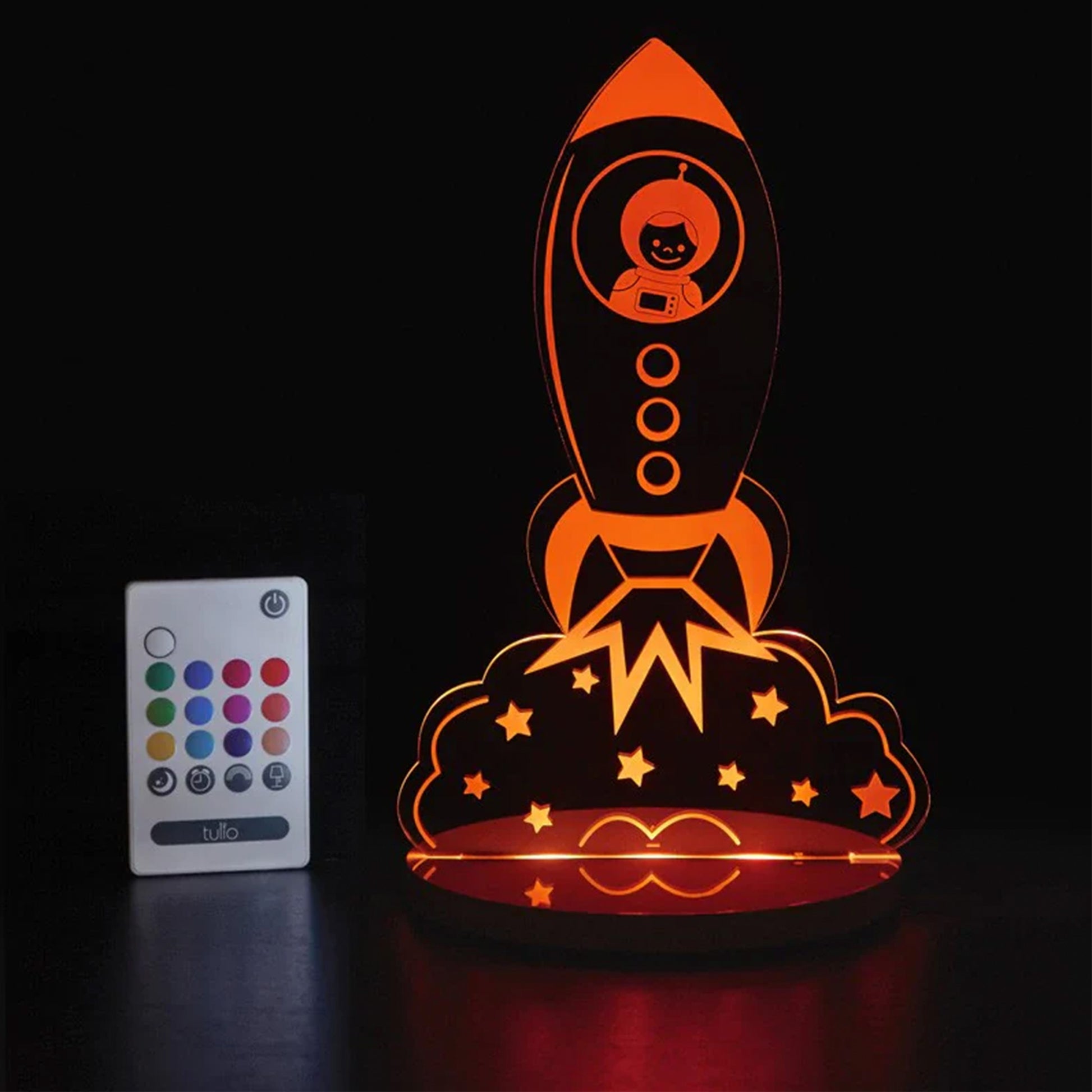 Ornamental rocket-shaped lamp with remote control on a black background