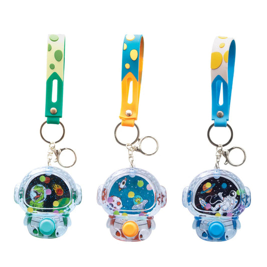 Three colorful keychains with space-themed designs on a white background