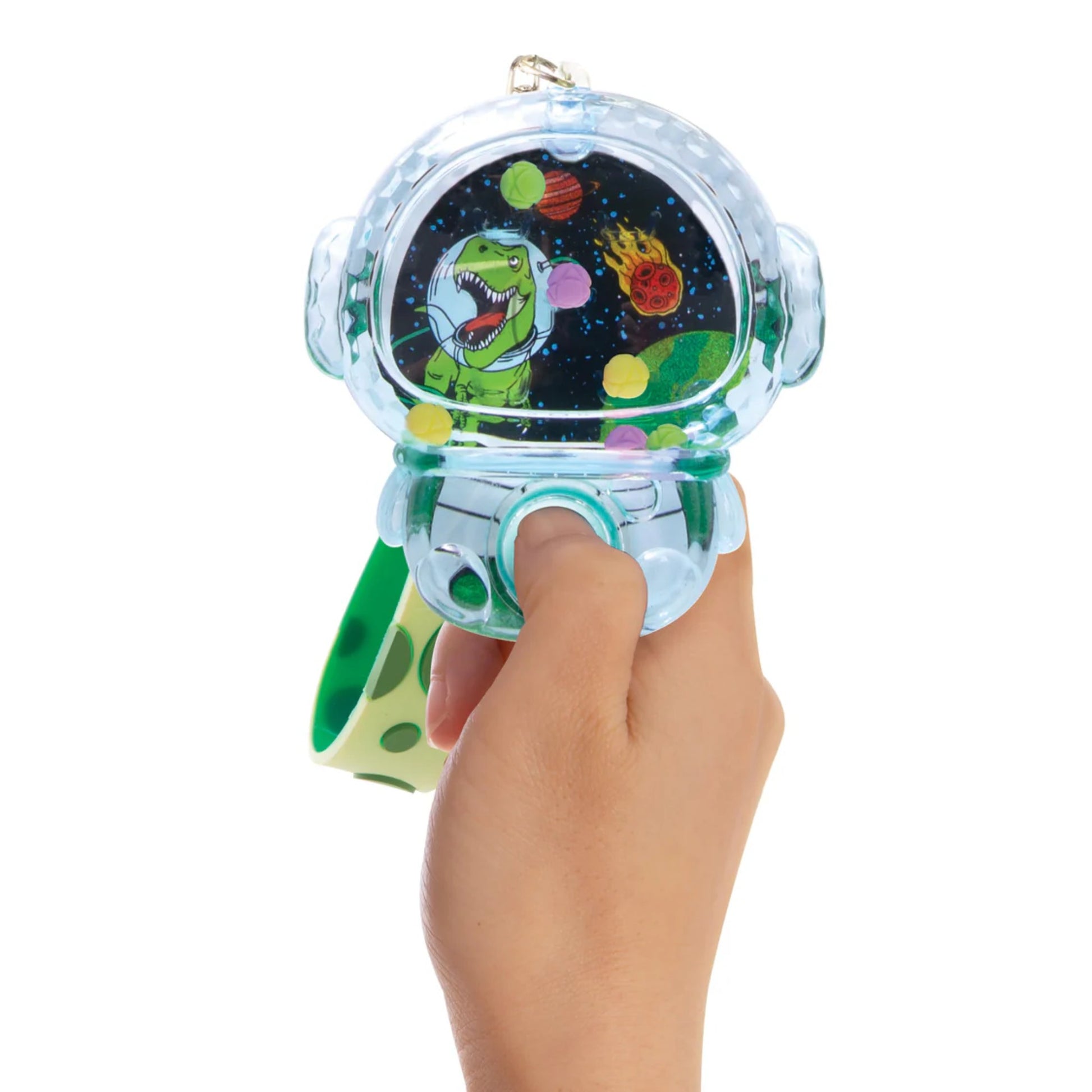 Hand holding a small bag with a space-themed design featuring a green character and planets.